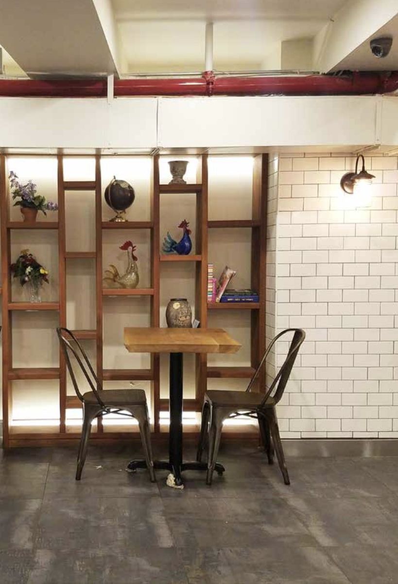 Custom wood shelving above cafe seating, Essen.