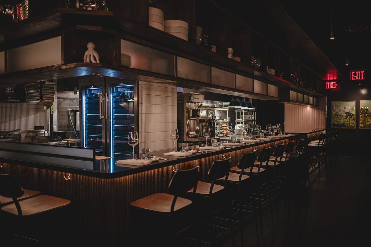 Chef's counter with timber stools facing the open kitchen, Jeju Noodle Bar.