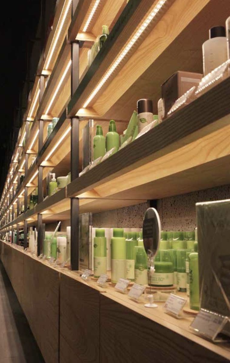 LED-lit oak shelving on steel supports, Nature Republic.